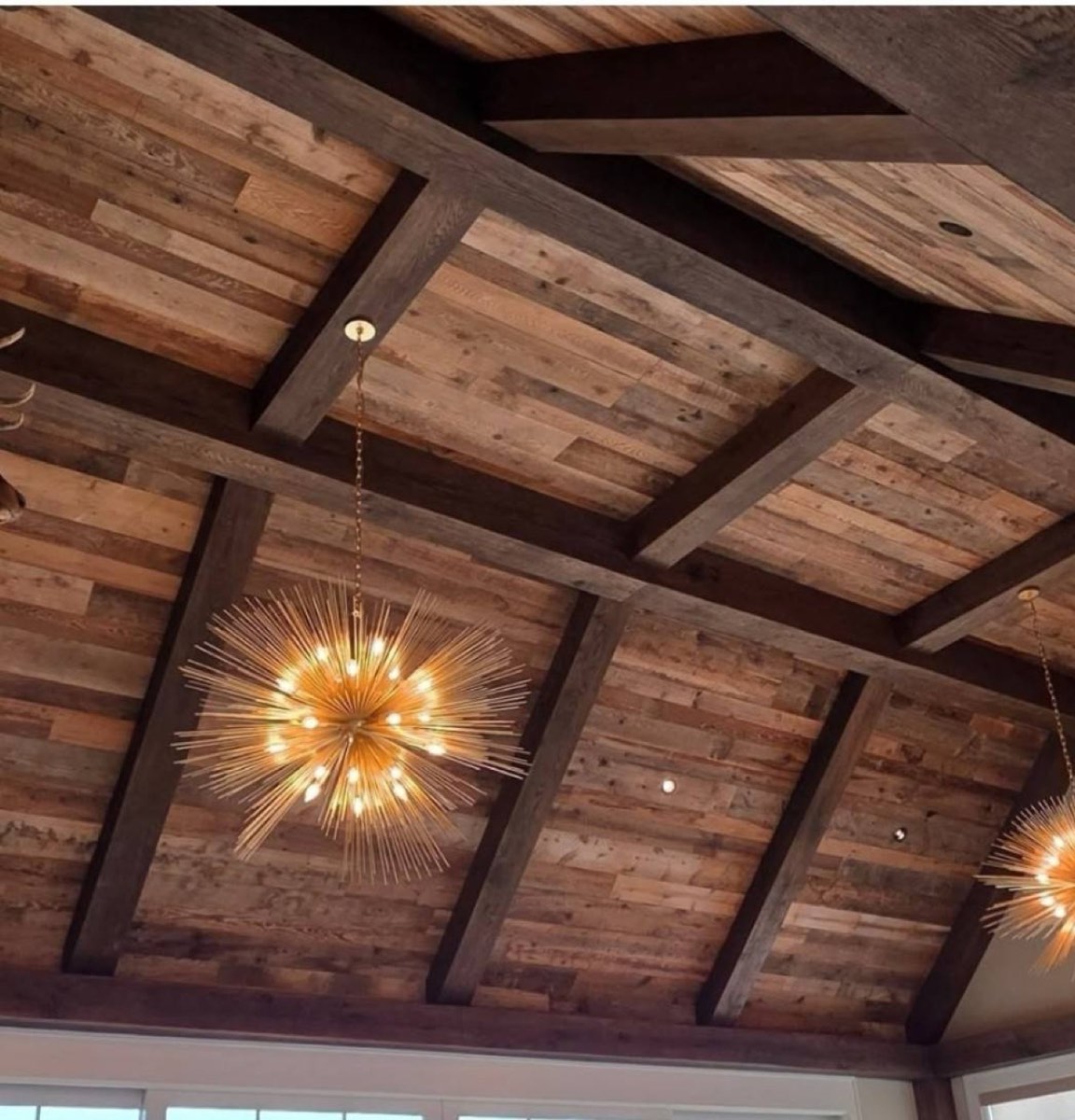 Close-up of reclaimed wood ceiling with exposed timber beam framing